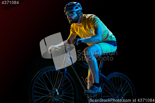 Image of The bicyclist on black, studio shot.