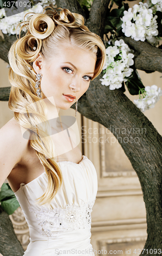 Image of beauty young bride alone in luxury vintage interior with a lot of flowers close up, bridal style