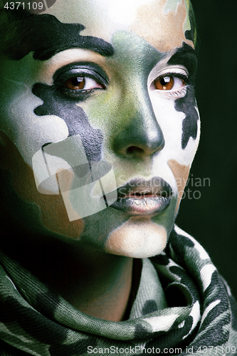Image of Beautiful young fashion woman with military style clothing and face paint make-up, khaki colors, halloween celebration