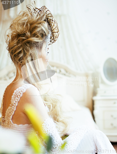 Image of beauty young bride alone in luxury vintage interior with a lot o