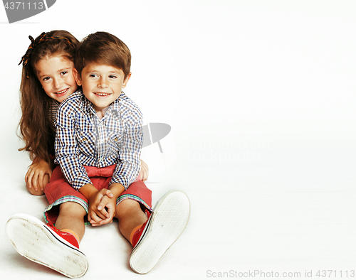 Image of little cute boy and girl hugging playing on white background