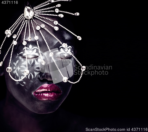 Image of creative makeup like print on face of young woman copyspace