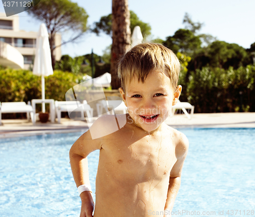 Image of little cute boy in swimming pool