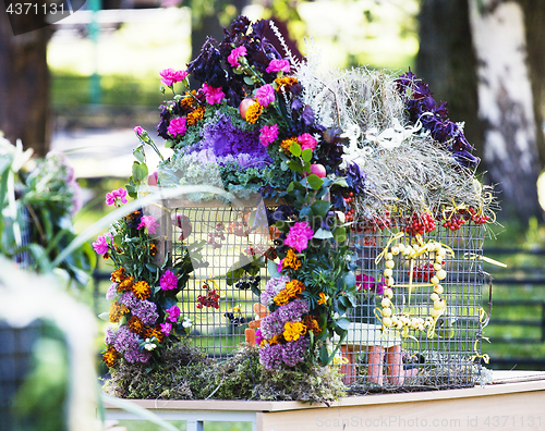 Image of picture of bright decorated with flowers bird house