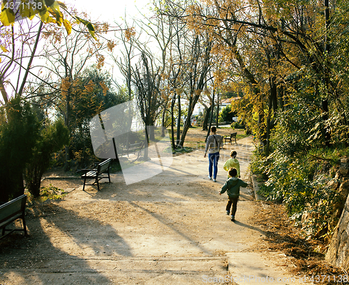 Image of cute family going away in green park, lifestyle people concept