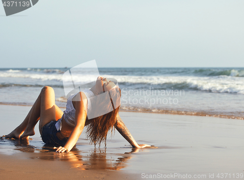 Image of real blonde girl along on seacost walking, healthy at sunrise