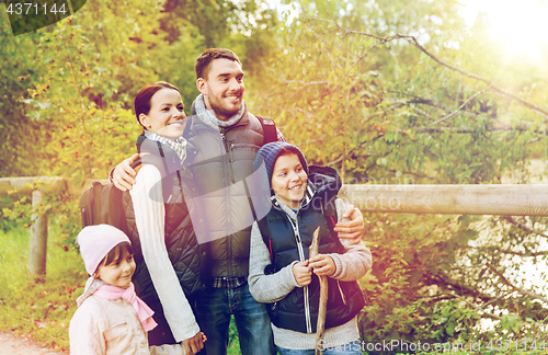 Image of happy family with backpacks hiking