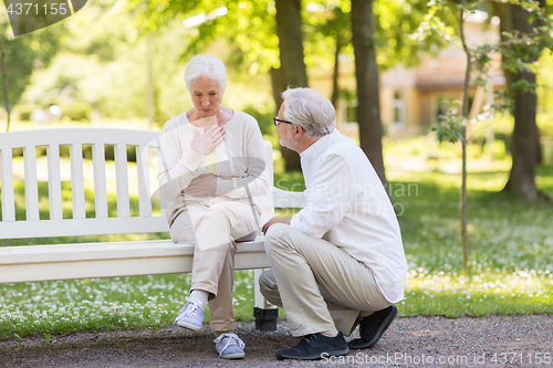 Image of senior woman feeling sick at summer park