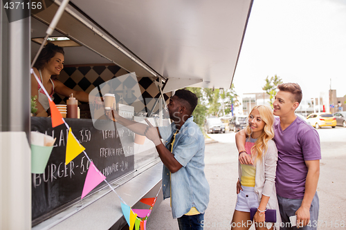 Image of happy customers queue at food truck