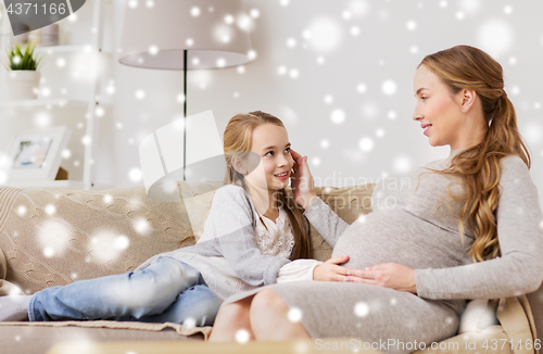 Image of happy pregnant woman and girl on sofa at home