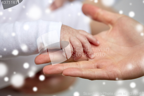 Image of close up of mother and newborn baby hands