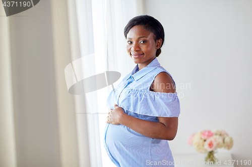 Image of pregnant african american woman at home