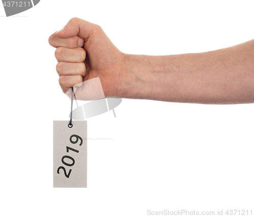 Image of Hand holding a tag - New year - 2019