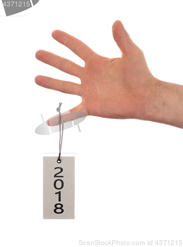 Image of Hand holding a tag - New year - 2018