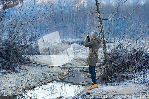 Image of Photographer shoots winter forest