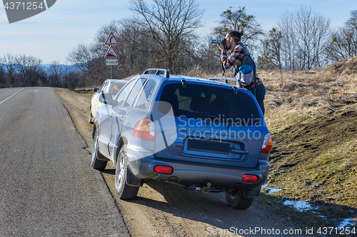 Image of Photographer takes pictures from the car