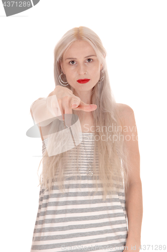 Image of Serious woman pointing finger at camera