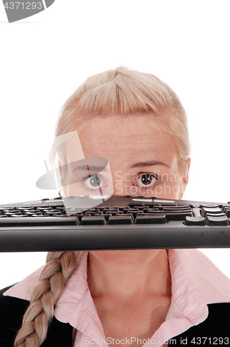 Image of Woman holding the keyboard over her face