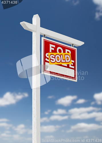 Image of Right Facing Sold For Sale Real Estate Sign on a Blue Sky with C