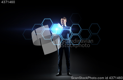 Image of businessman working with virtual network hologram