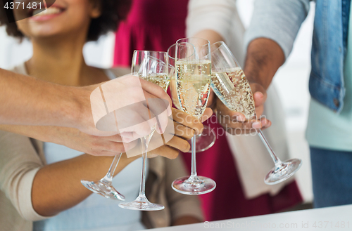 Image of friends clinking glasses of champagne at party