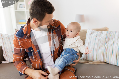 Image of happy father with little baby boy at home