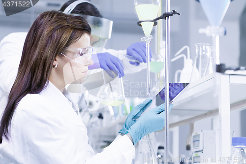 Image of Chemists researching in life science laboratory.