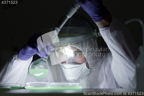 Image of Life scientist researching in bio hazard laboratory. High degree of protection work.