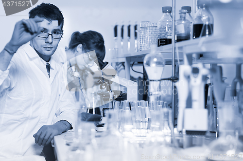 Image of Health care professionals microscoping in scientific laboratory.