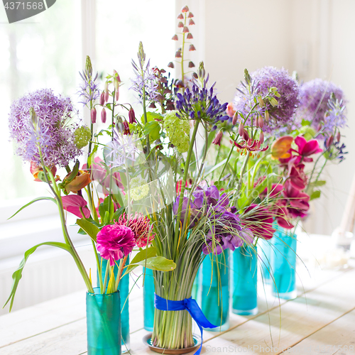 Image of Beautiful spring flowers on wooden table.