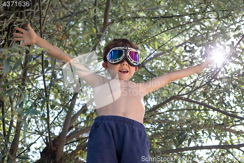 Image of Happy little boy playing outdoors.