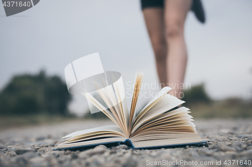 Image of open book lying on the road.