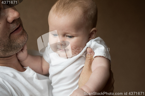 Image of Father Holding Newborn Baby Son