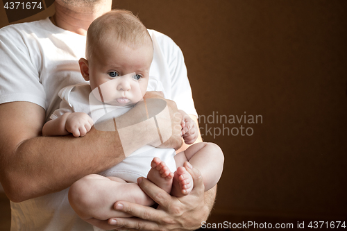 Image of Father Holding Newborn Baby Son