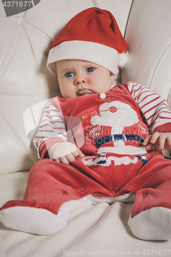 Image of Happy  baby in Santa costume. 