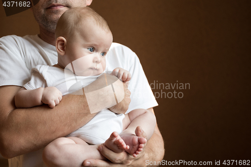Image of Father Holding Newborn Baby Son