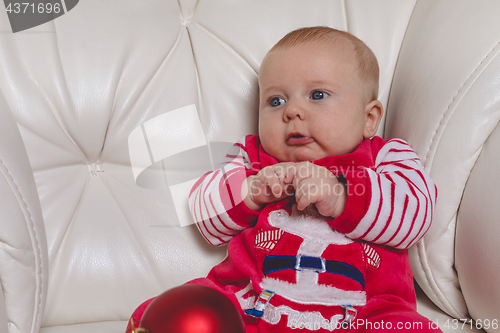 Image of Happy  baby in Santa costume. 