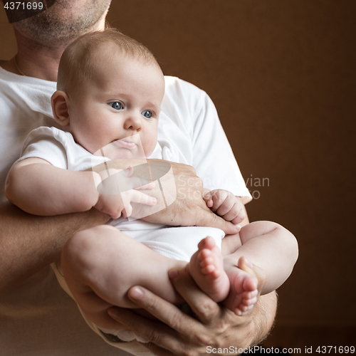 Image of Father Holding Newborn Baby Son