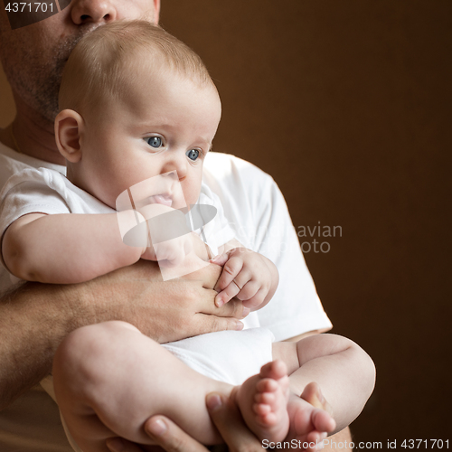 Image of Father Holding Newborn Baby Son