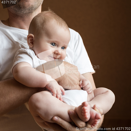 Image of Father Holding Newborn Baby Son