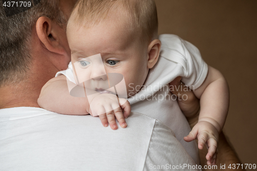 Image of Father Holding Newborn Baby Son