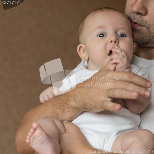 Image of Father Holding Newborn Baby Son