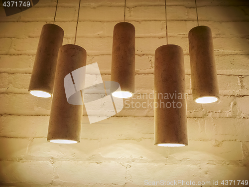 Image of Concrete industrial design lamps in sepia tones