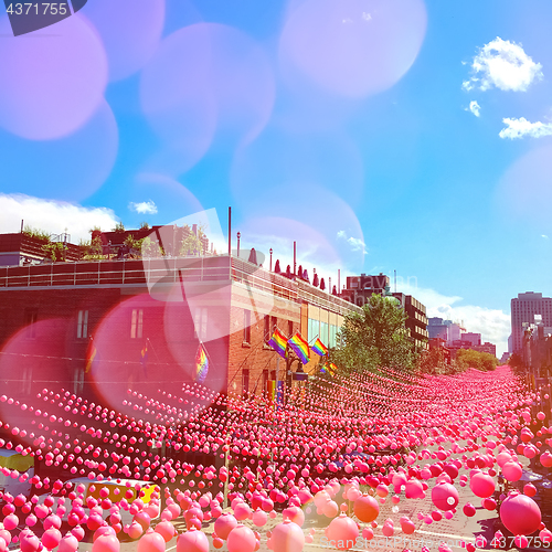 Image of Summer party street in gay neighborhood decorated with pink ball