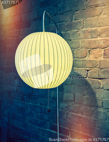 Image of Retro style image of a wall lamp with round lampshade