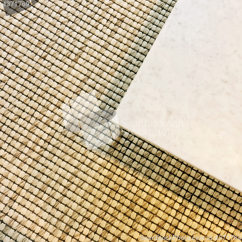 Image of Corner of a marble table on carpet floor