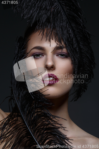 Image of Beautiful girl with black feathers