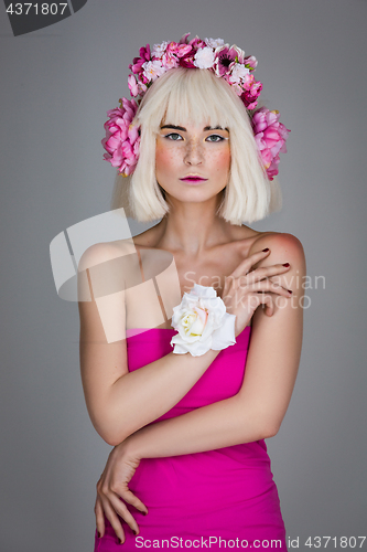 Image of Beautiful girl in pink dress with floral head accessory