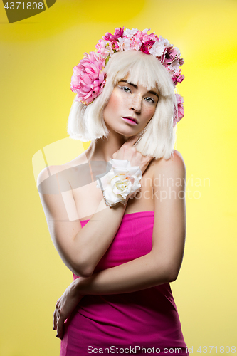 Image of Beautiful girl in pink dress with floral head accessory