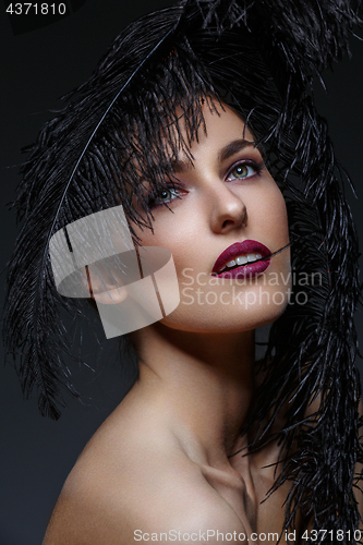 Image of Beautiful girl with black feathers
